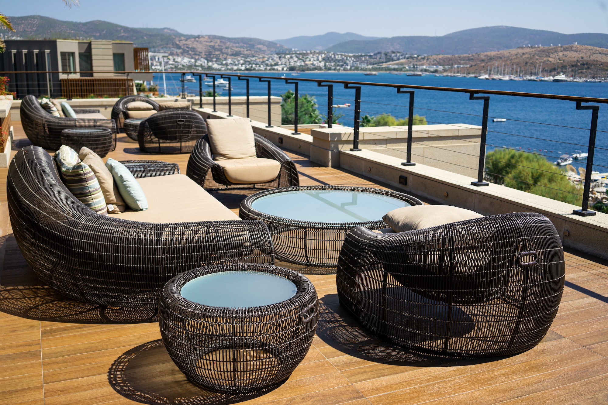 terrace-lounge-with-rattan-armchairs-sofa-and-seaview-in-a-luxury-resort-hotel.jpg